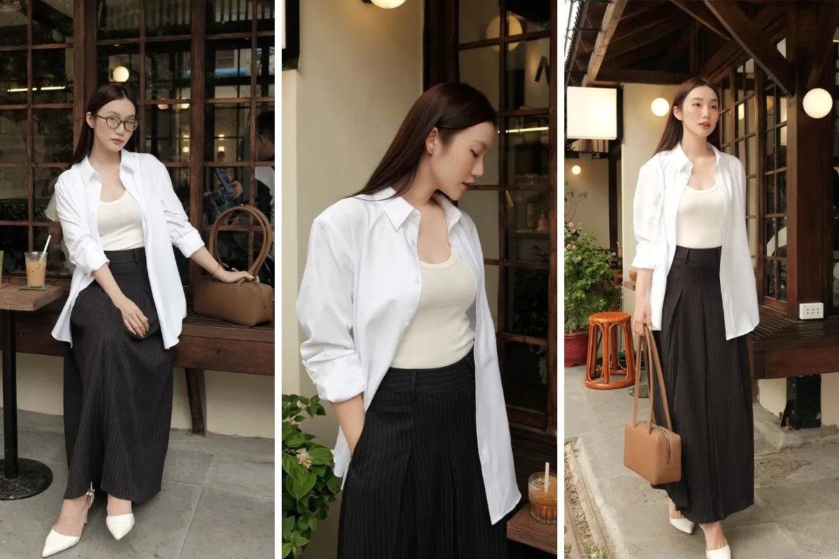 Màu trắng của áo sơ mi tạo sự tương phản tinh tế với sắc đen của chân váy, mang đến vẻ đẹp trang nhã, thanh thoát